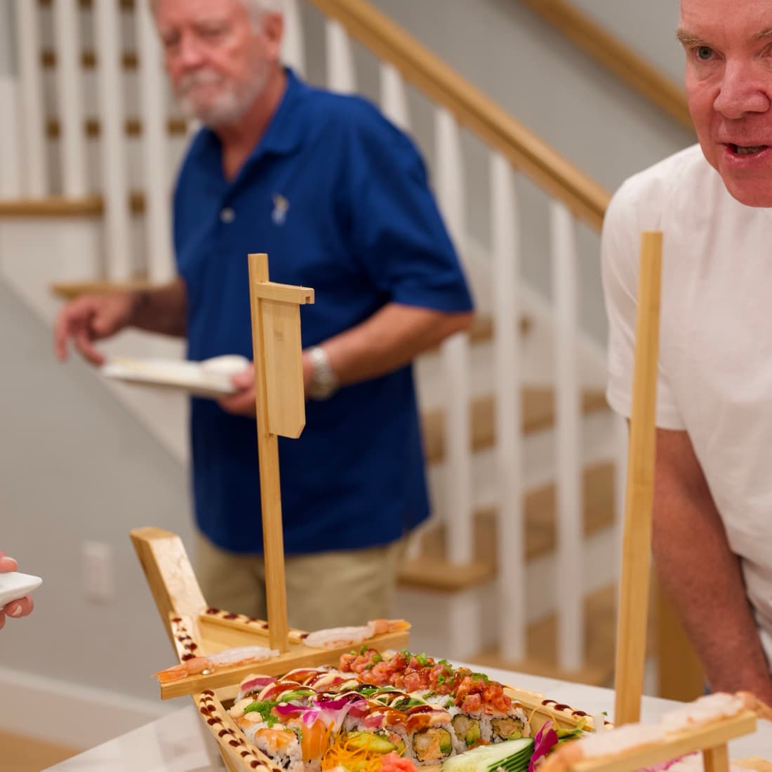 Guests gathering around the sushi boat as it comes out.