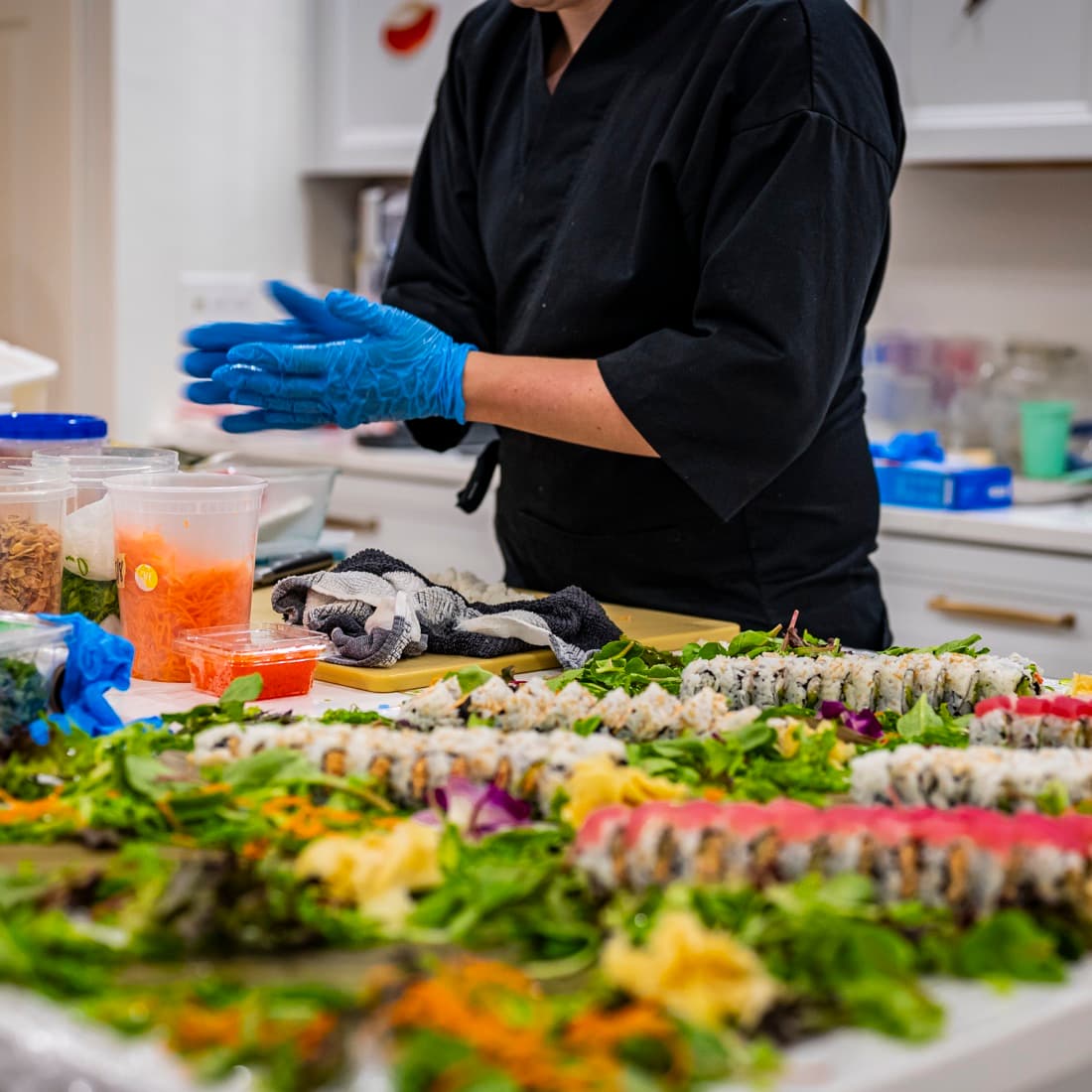 Chef preparing a full sushi spread at a private event.