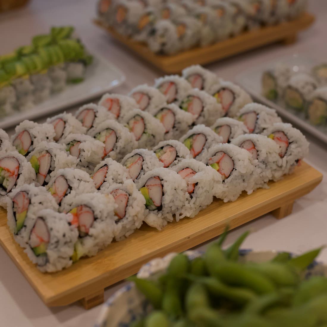 Rows of freshly cut rolls on a wooden board.