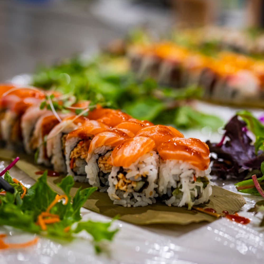 Close-up detail of sushi rolls on a wooden serving board.